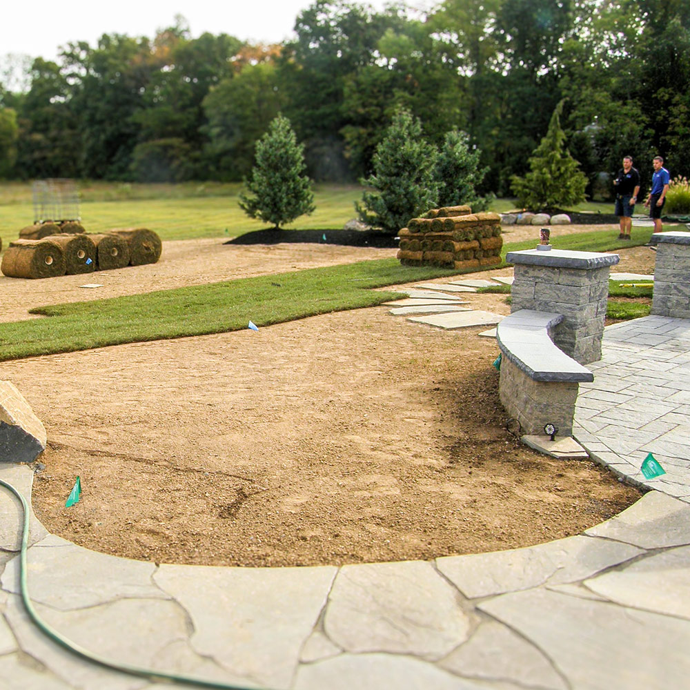 Lingo Group crew working turf on a property where lawn aeration in Bucks County, PA was part of the plan