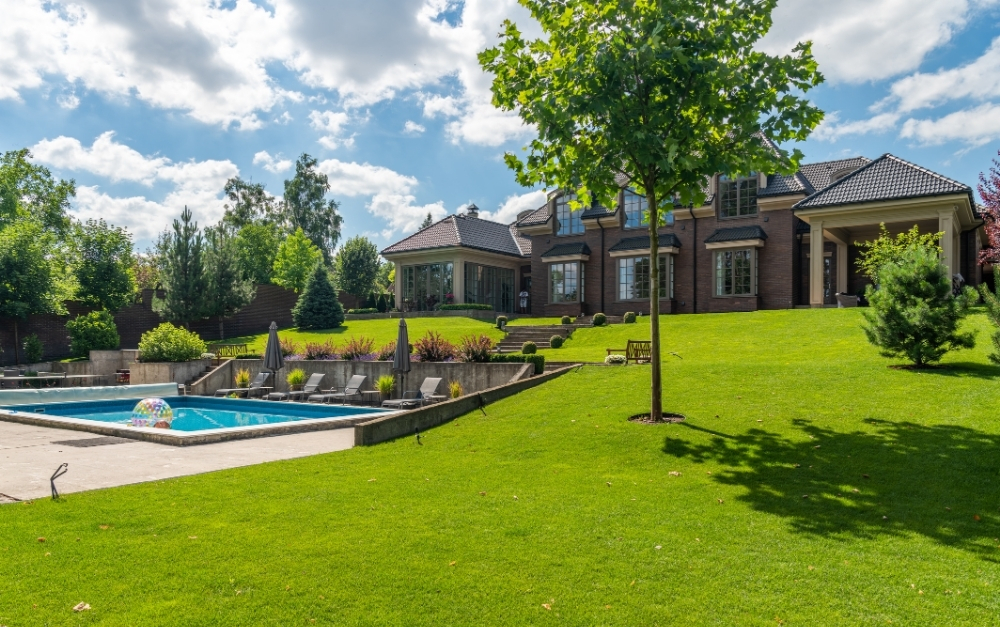 Stunning low-voltage landscape lighting installed on a stone patio in Bucks County by The Lingo Group