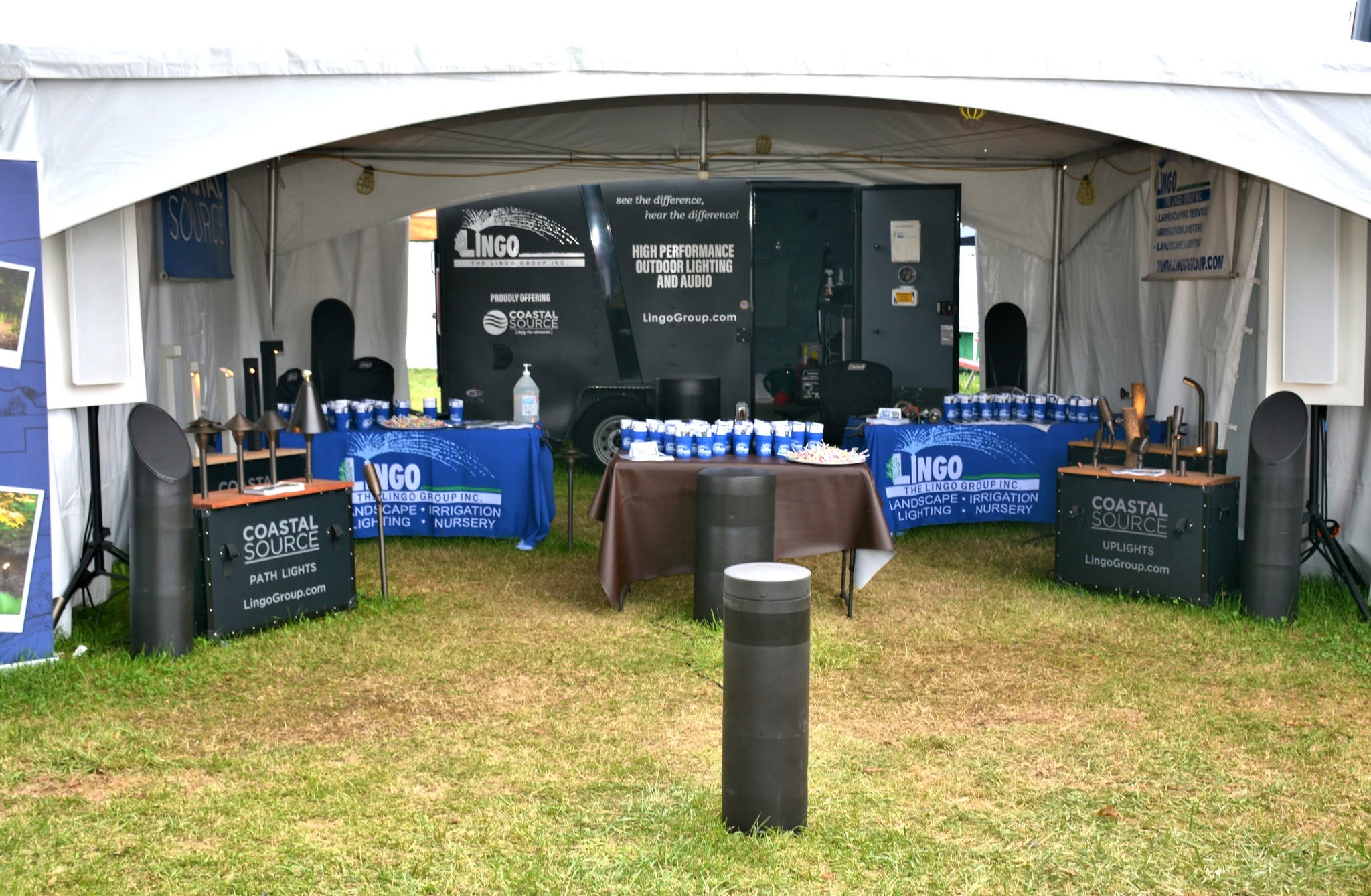 The Lingo Group outdoor audio and lighting display showing Coastal Source speakers and path lights at a Bucks County show