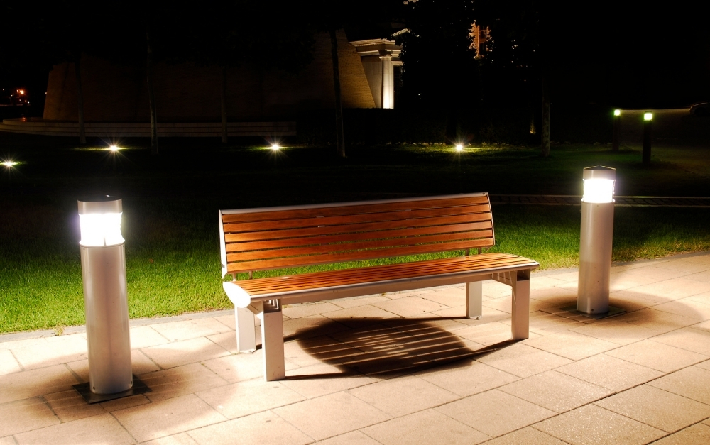 Warm landscape lighting blending beautifully with residential outdoor wall lights